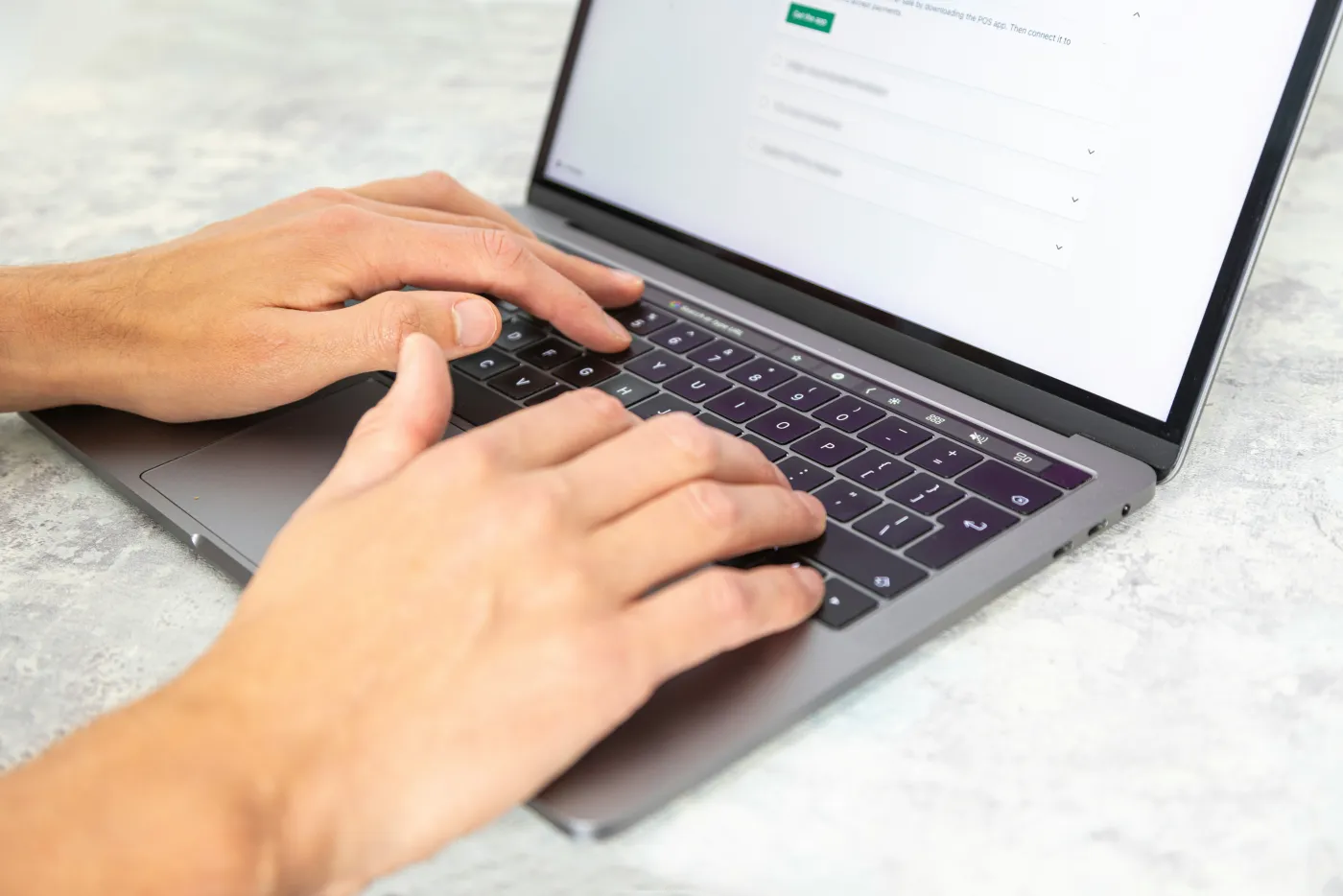 Hands building a website at a laptop