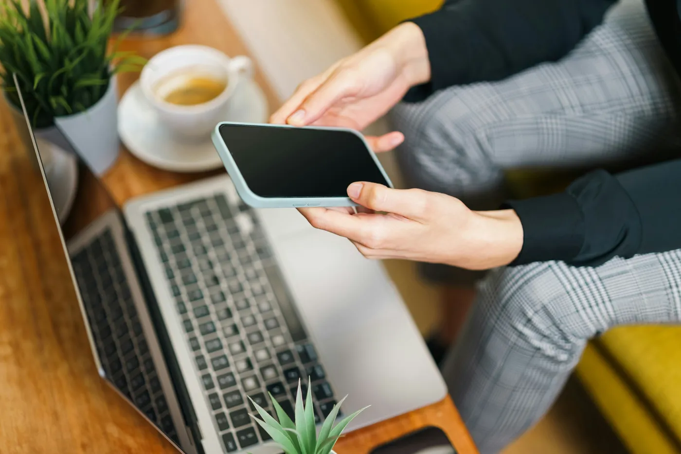 An owner checking her business from her own phone and laptop